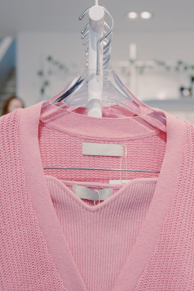 Dusty rose-pink V-neck top on a hanger